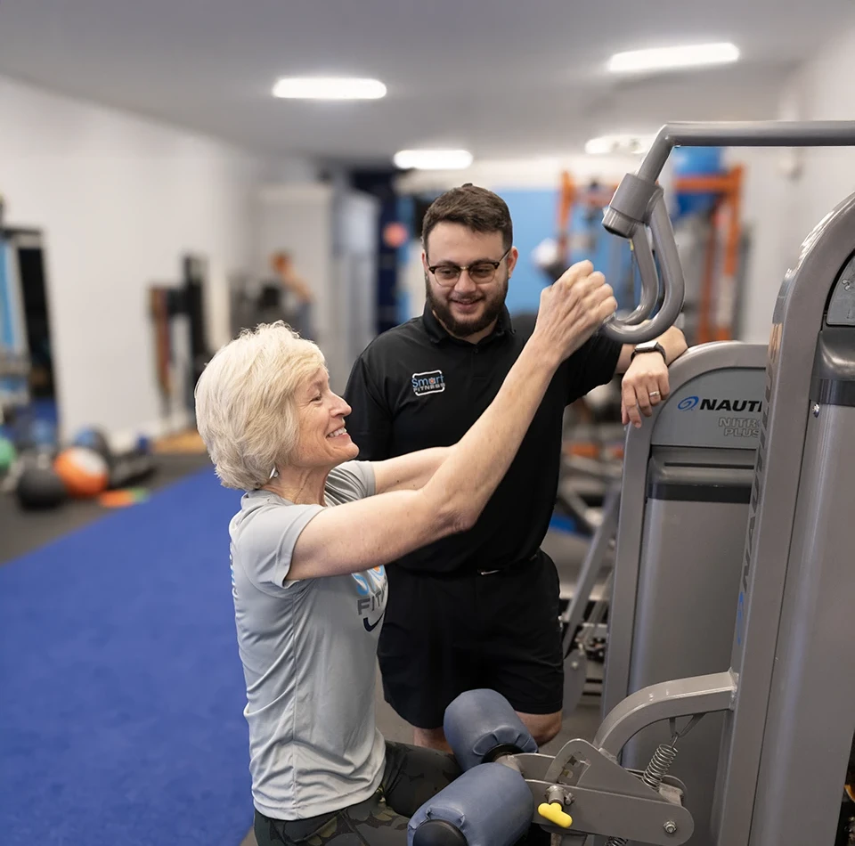 woman training with her personal trainer at Smart Fitness